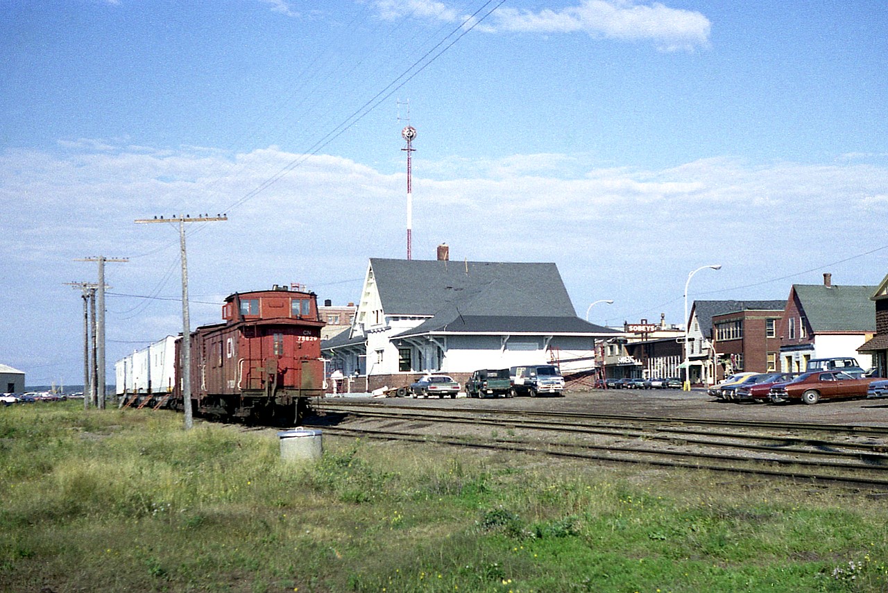 Lets just say this image is for those on Railpictures that either reside on PEI or are frequent visitors, as this is just a general scene. It features the CN Summerside station (now a library)and a boarding car train left on the southernmost track in the diminutive 'yard'. Some of the downtown business district is on the right and in the distance ahead of the cars is the track running left to the pier, which was active at this time as I saw CN 1750 switching and a ship at anchor. A nice old time scene, as the railroad is now gone from the Island (1989) and the track area is now parking lot for the Loyalist Lakeview Resort. The mainline is now Confederation Trail.