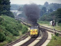 Not the sort of scene a Climate Buff would care to see, but this display of MLW smoke as a treat for us fans on the hillside overlooking The Junction.  VIA #75 is westbound, the time is 1810Hrs and it is a very warm and humid eve. THAT I remember. VIA 6761 leads, trailing 6871 smokes. Perhaps it still smokes, as the offending unit now toils for the Grand Canyon Railway as their 6871 !! I count 9 coaches on a rather short train in this image, another of a series I had taken 40 VIA years ago. August 23rd was a Wednesday............