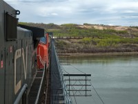 Looking railway east as we cross the North Saskatchewan River just west of North Battleford with train A411. The location I took http://www.railpictures.ca/?attachment_id=33984 from is visible just above the 8th covered hopper back. I don't remember why 411 was so early/late on this day but something must have happened, usually it would be called some time between 2200 and 0200.   
