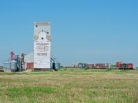 CN 108 passes the former Pool elevator at Reford Saskatchewan. You can tell this is the former GTP mainline by the vast distance between the elevator and the right of way. 