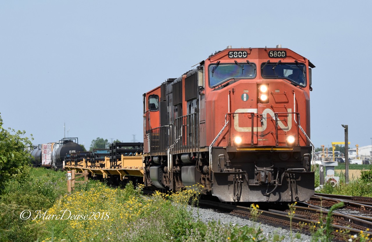 The daily 509 train departs Sarnia about to cross Blackwell Sideroad with CN 5800 and CN 5692.