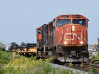 The daily 509 train departs Sarnia about to cross Blackwell Sideroad with CN 5800 and CN 5692.