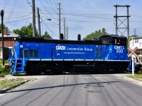 GMTX 333 crosses Railroad st and the CN Halton (out of sight on the south side of the road) at exactly 11:15am as it leads half a dozen freight cars to Mississauga for interchange with CP. 