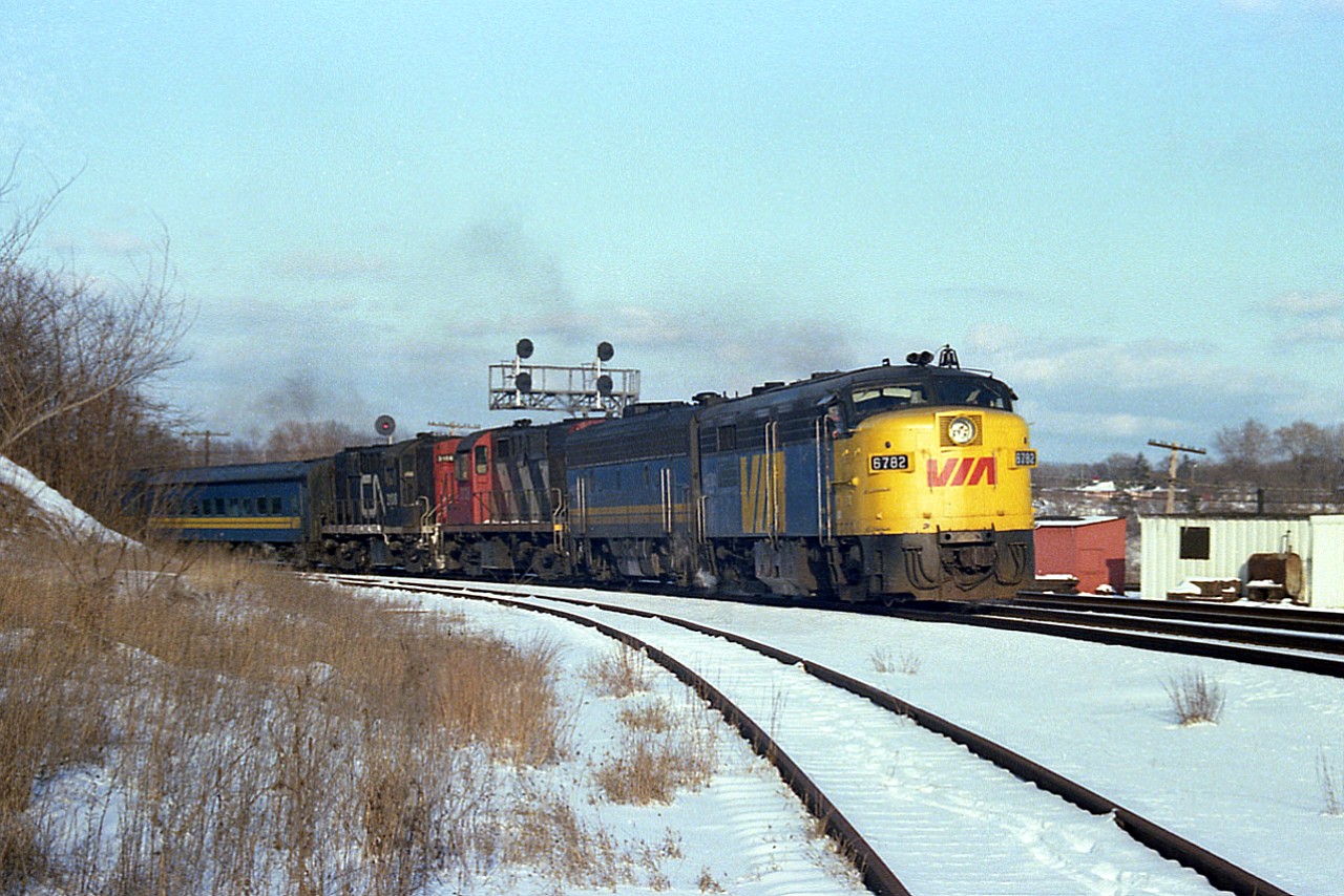 Ya gotta enjoy a nice colourful train like this on a blustery cold day. It warms the soul! For quite a while, the late afternoon/early eve VIA #75 west provided us train nuts with some interesting power. Once again coming thru "with the goods" for us fans, VIA 6782, 6615, CN 3129 and 3108 are sufficient power to tackle the long grade west thru Copetown on what actually, by this photo, looks warmer than the bitter day that it was. Note the engineer keeping a watch on his train as it enters the curve.
