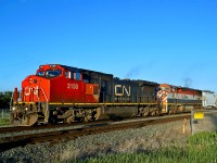 In the evening sun Dash 8-40CW CN 2150 (ex BNSF 830) and Dash 8-40CMu BCOL 4602 lead a westbound freight through Ardrossan.