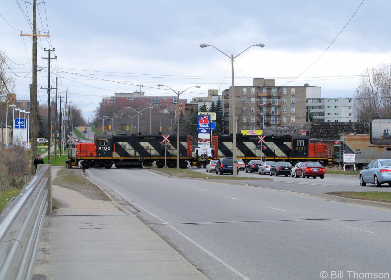 The local wayfreight with CN GP9RM's 4100 and 4132 is seen crossing Bath Road on the 3-mile Cataraqui Spur in Kingston, heading back after switching the Invista (formerly Dupont) plant to the south.