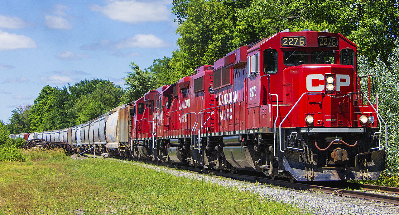 Havelock's prosperity as a town is owed to the railway. The town was built in a simple grid pattern north of it's expansive rail yards. The line was built by the Ontario & Quebec Railway, which later was gobbled up by the Canadian Pacific. But it always remained a busy divisional point for trains traveling between Ottawa and Toronto. Eventually passenger service was turned over to VIA Rail, and the trains still called at Havelock until the infamous Mulroney cuts in 1990. After that, CP traffic dwindled, and so too did the physical state of the town's beautiful station. However, all was not lost. The Kawartha Lakes Railway was formed and like so many shortline operations in Ontario, leases the line from CP as well as it's motive power. 


On a recent trip to Perth, and while passing through I was lucky enough to see some action on the once busy mainline. Here on Industrial Rd. CP 2276 and two others back into the still active yard while continuing to build their train. Just behind me and quite overgrown, the rest of the former O&Q mainline used to continue on through smaller communities like Kaladar, Bathurst and Glen Tay.