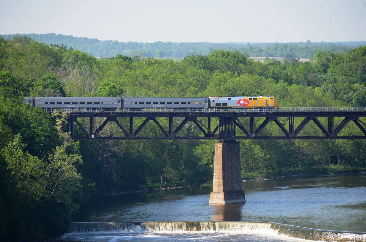 Long-shot of a VIA passenger train at Paris; lead unit wearing "40 years" (of VIA rail) skin