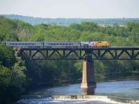 Long-shot of a VIA passenger train at Paris; lead unit wearing "40 years" (of VIA rail) skin