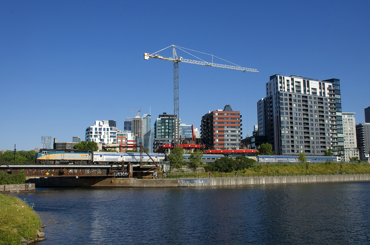 VIA 601 and VIA 603 for Northern Quebec are joined as they pass the Peel Basin in Montreal with VIA 6439 leading and VIA 6455 mid-train. At Hervey Jct the train will split, with 601 heading for Jonquière and 603 heading for Senneterre.