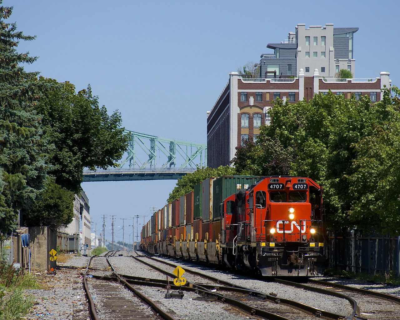 The Pointe St-Charles Switcher is getting ready to leave the Port of Montreal with GP38-2 CN 4707 & GP9 CN 7054 for power and a train consisting almost entirely of intermodal traffic.