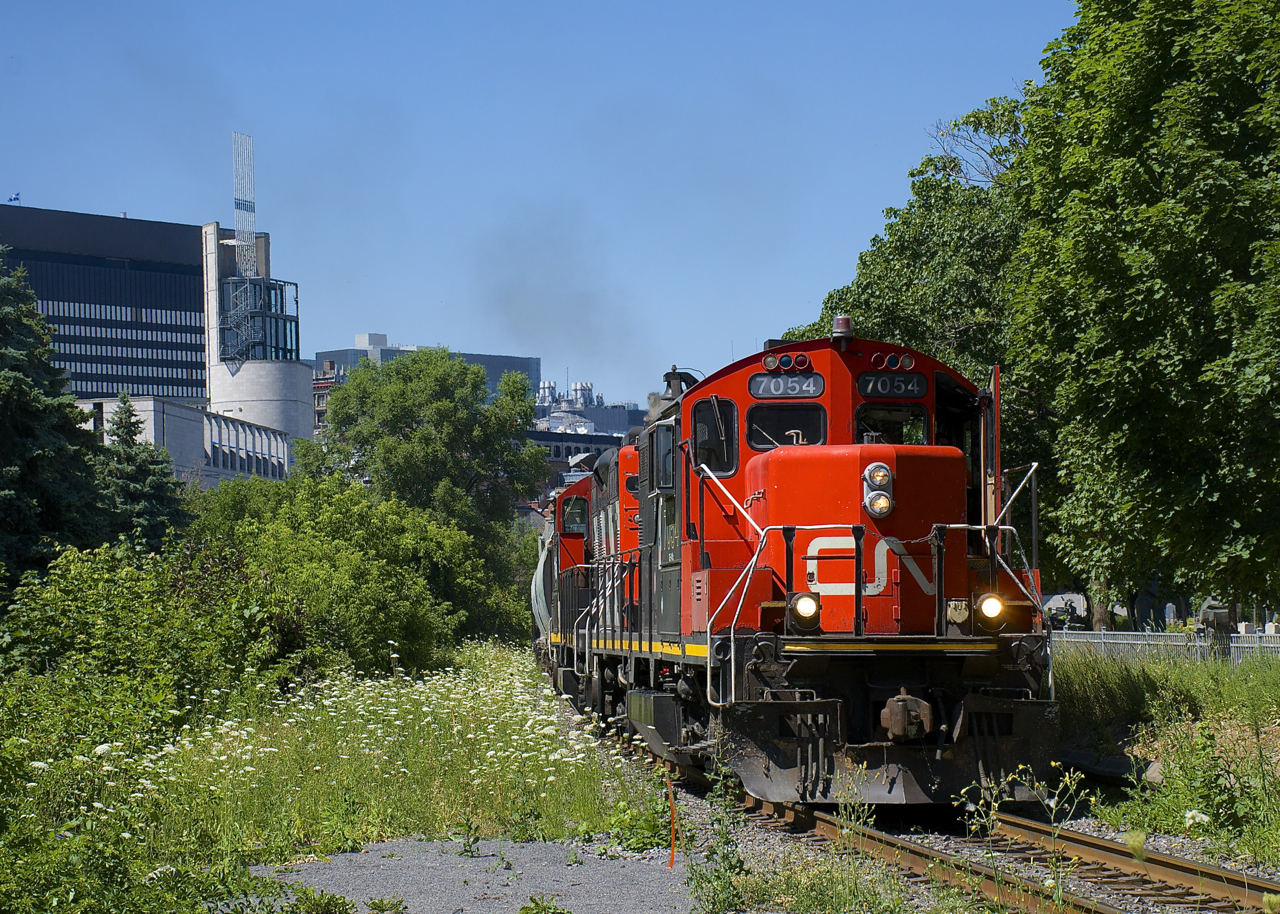 A transfer is leaving the Port of Montreal, with GP9's CN 7054 & CN 4115 in charge of forty-six cars.