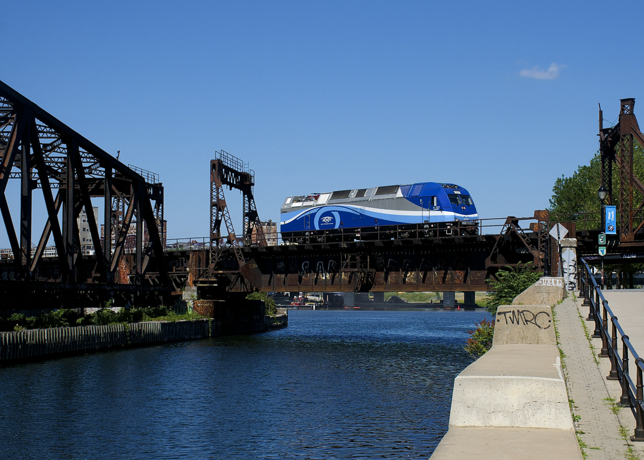 Calling itself the roustabout on the scanner, this light engine move of ALP-45DP AMT 1357 was seen heading east over the Lachine Canal (as seen here) and then backing up towards Central Station in Montreal a few minutes later. Presumably this job switches the nearby Pointe St-Charles Maintenance Centre and brings equipment between there and Central Station.