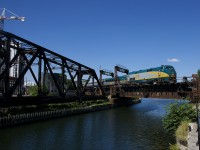 After having come in as VIA 62 and then wyeing on the nearby Victoria Bridge, a consist made up of VIA 917 and LRC cars is backing up to Central Station in Montreal to become VIA 69.