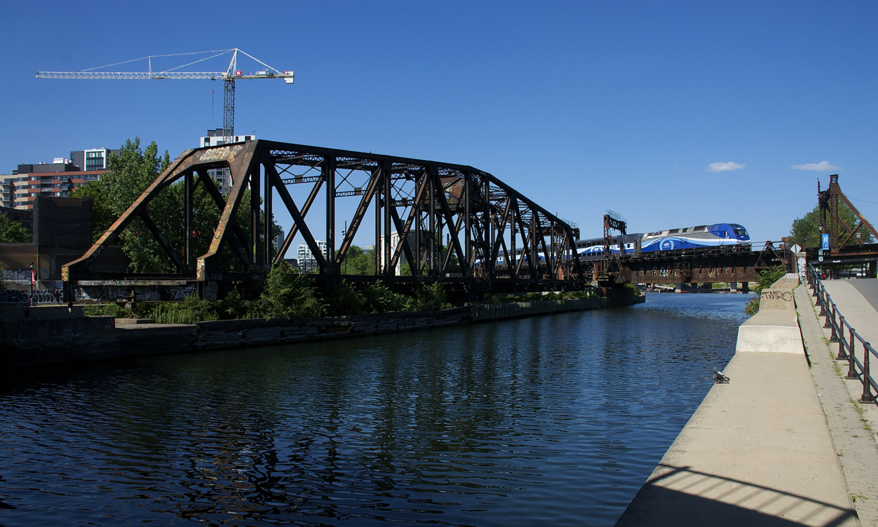 RTM 810 is crossing the Lachine Canal on its way to Mont-Saint-Hilaire as it passes the long out of use CN swing bridge that is now locked in place.