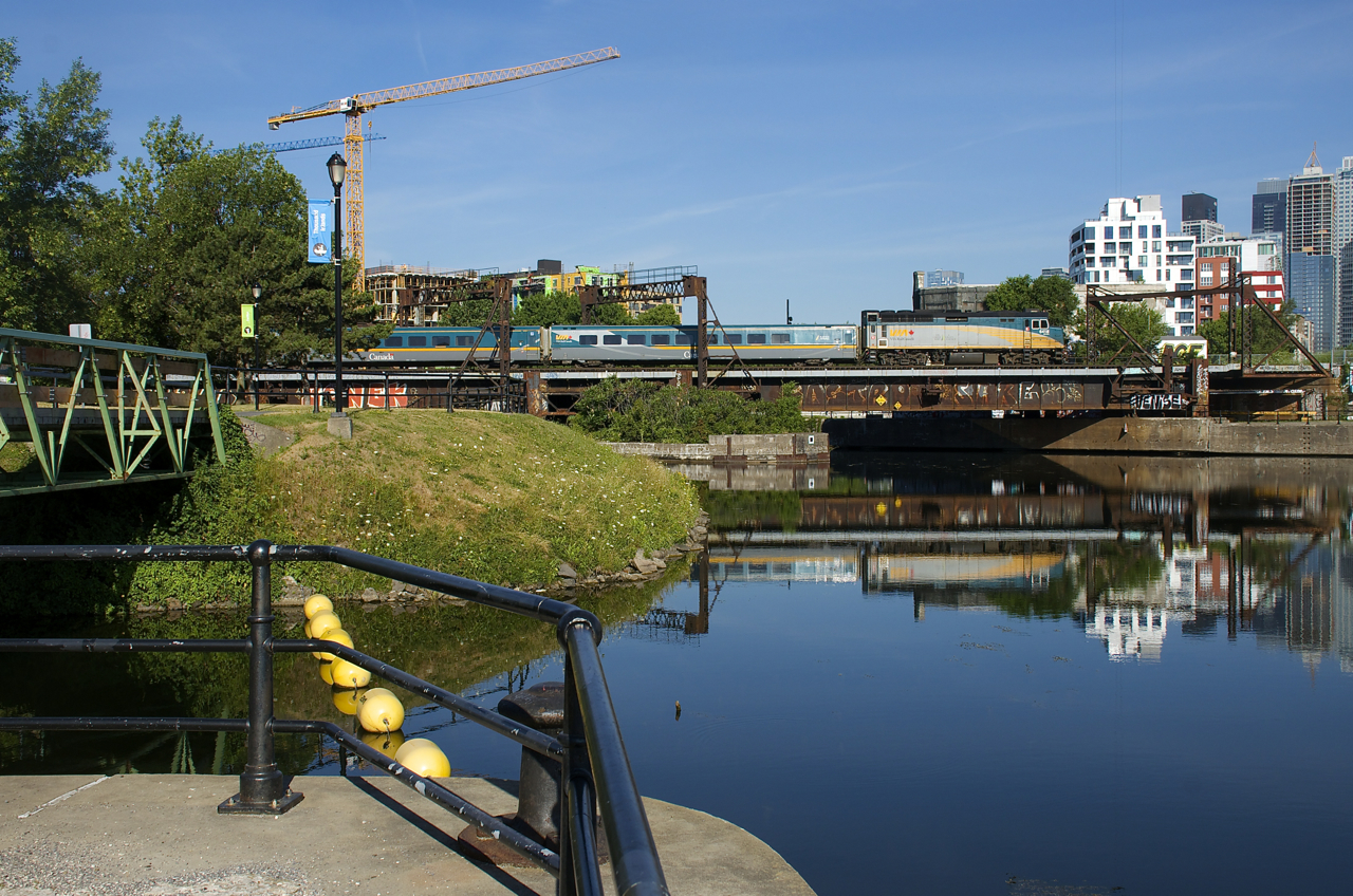 VIA 22 with VIA 6418 leading is passing Wellington Tower, just five minutes out from Central Station in Montreal.