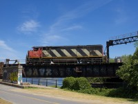 This section of CN's St-Hyacinthe Sub is normally passenger-only, with VIA Rail, Amtrak and RTM passenger trains passing over the Lachine Canal on the way to and from nearby Central Station. However once in a blue moon freight power will pass this way so that they can reverse towards the Victoria Bridge and wye their power and that is the case here. CN 527 arrived in Pointe St-Charles Yard with CN 2401 as the sole power, long hood forward. While waiting for the Pointe St-Charles switcher to arrive from the Port of Montreal with cars for them, they decided to wye their unit so that they could run to Taschereau Yard with the power running short hood forward. Here it is backing up over the Lachine Canal on the way to wyeing the power.