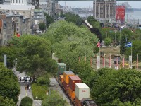 A CN transfer is leaving the Port of Montreal with CN 7054 & CN 4707 leading 56 cars, with intermodal up front and mixed freight behind it.