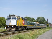 VIA 635 has wrapped VIA 6402 leading four LRC cars as it heads through the St-Henri neighbourhood of Montreal, on its way to Ottawa.