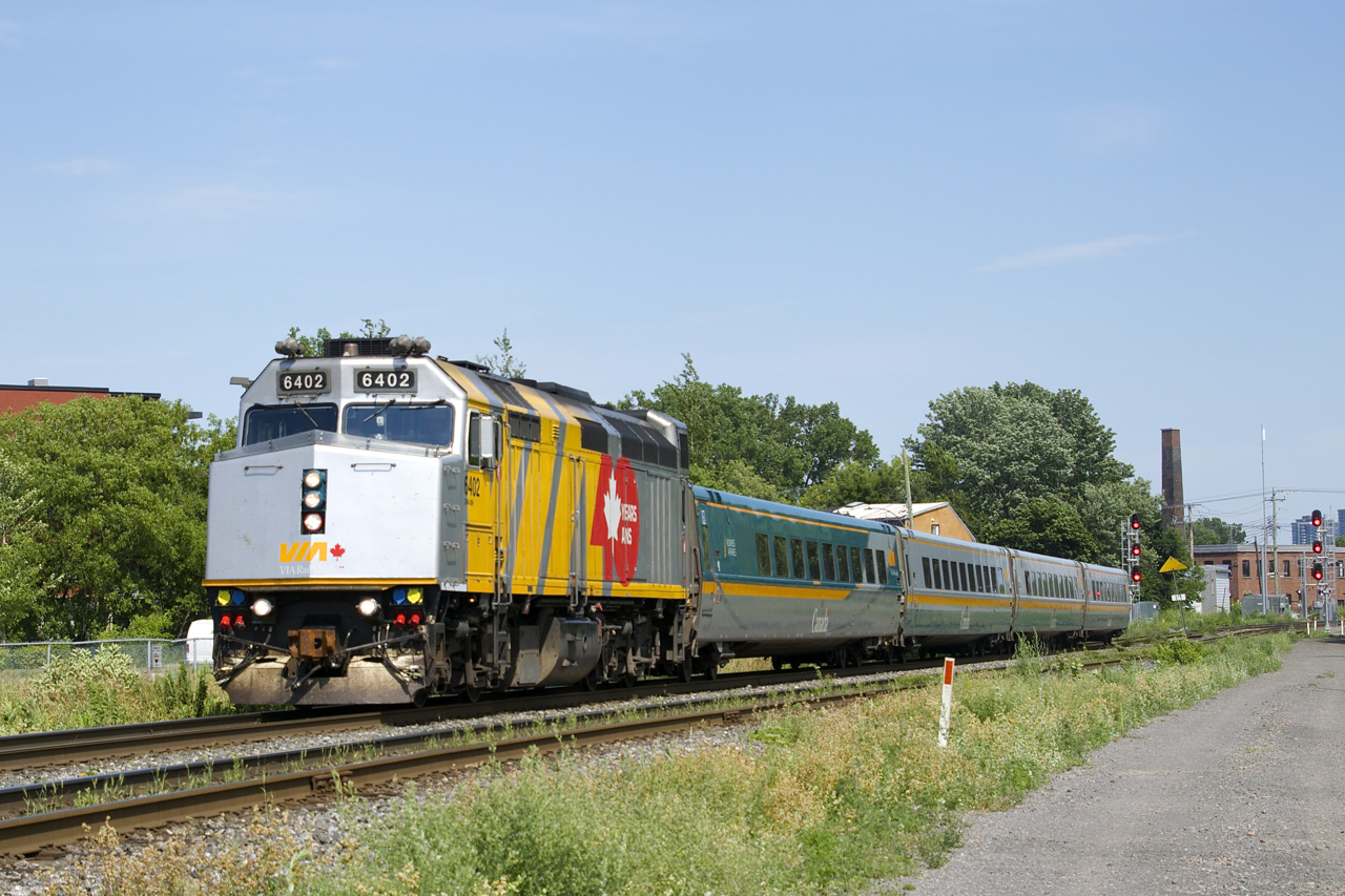 VIA 635 has wrapped VIA 6402 leading four LRC cars as it heads through the St-Henri neighbourhood of Montreal, on its way to Ottawa.
