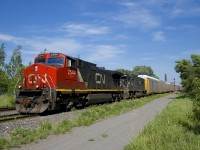 After holding on the Butler Spur for a short time waiting for VIA 26 to pass, CN 401 is on the move again with CN 2544 & IC 1020 for power as it heads west towards its terminus of Taschereau Yard.