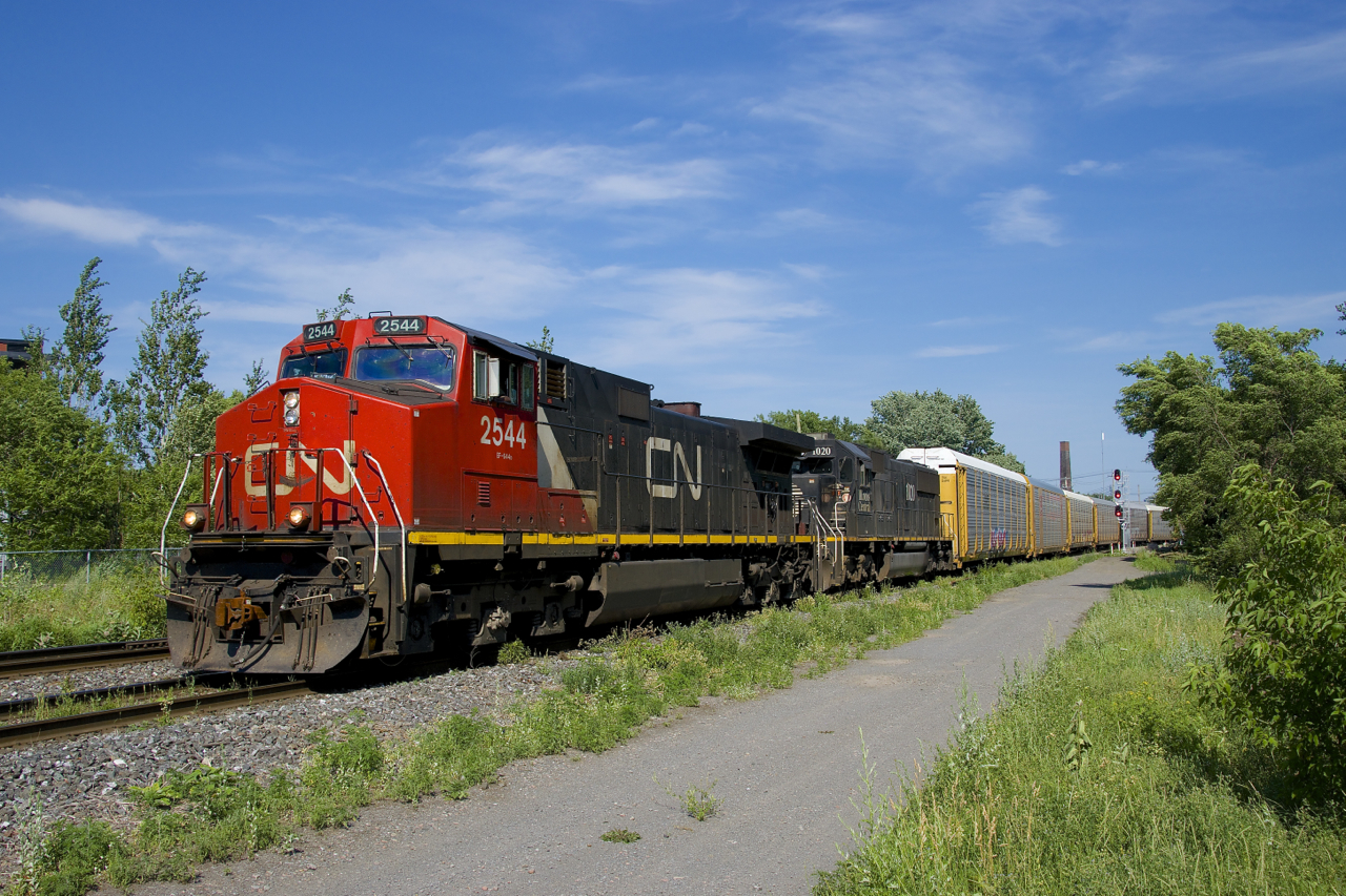 After holding on the Butler Spur for a short time waiting for VIA 26 to pass, CN 401 is on the move again with CN 2544 & IC 1020 for power as it heads west towards its terminus of Taschereau Yard.