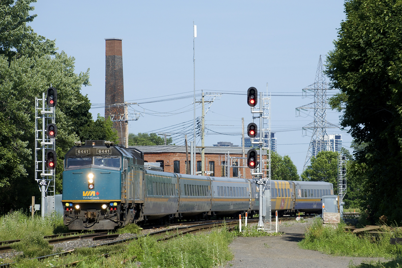 VIA 6441 leads VIA 67 by a set of signals with five LRC cars in tow.