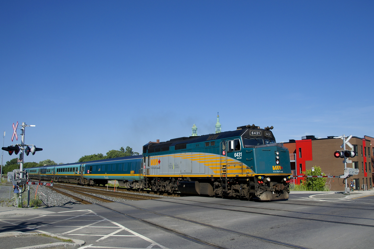 VIA 637 has VIA 6431 and a Renaissance consist as it crosses De Courcelle, on its way to Ottawa.