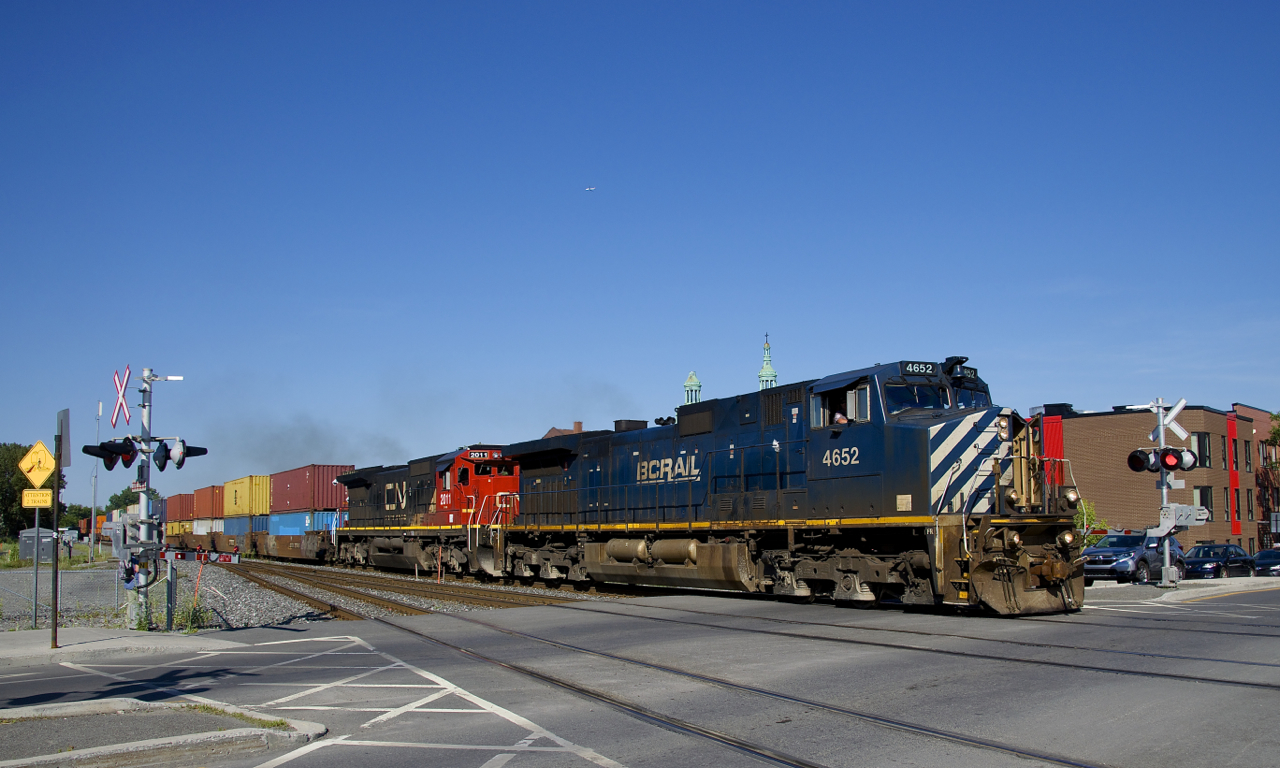 After lifting cars at Pointe St-Charles Yard (including intermodal from the Port of Montreal), CN 527 is on its way to Taschereau Yard as it passes over the De Courcelle crossing with a nice lashup of BCOL 4652 & CN 2011 on a sunny evening.