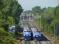 F59PH's AMT 1342 and AMT 1340 are meeting at speed on CP's triple-track Westmount Sub during the morning rush hour. AMT 1342 at left is heading east with RTM 112 from Hudson, while AMT 1340 at right is pushing a deadhead move west.