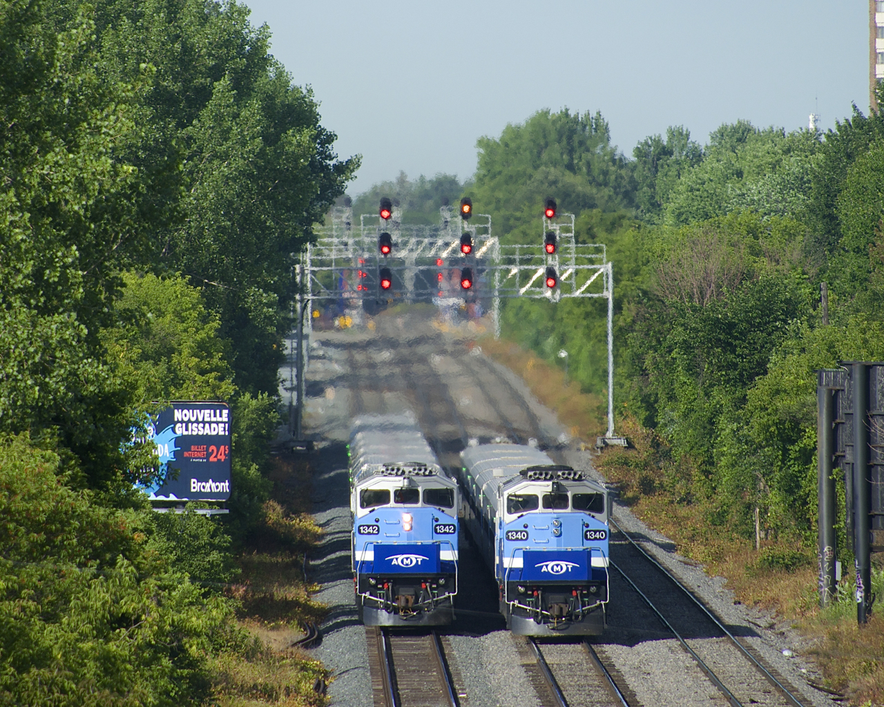 F59PH's AMT 1342 and AMT 1340 are meeting at speed on CP's triple-track Westmount Sub during the morning rush hour. AMT 1342 at left is heading east with RTM 112 from Hudson, while AMT 1340 at right is pushing a deadhead move west.
