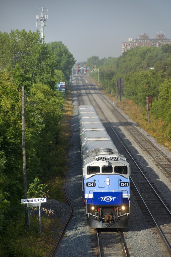 AMT 1341 is passing the advance station sign for Montreal West, located one mile to the west of the sign.