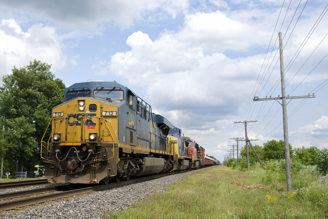 An 85-car CN 327 is westbound on the south track of CN's Kingston Sub with CSXT 712, ex-CSX unit GECX 7865 & CN 2274 for power.