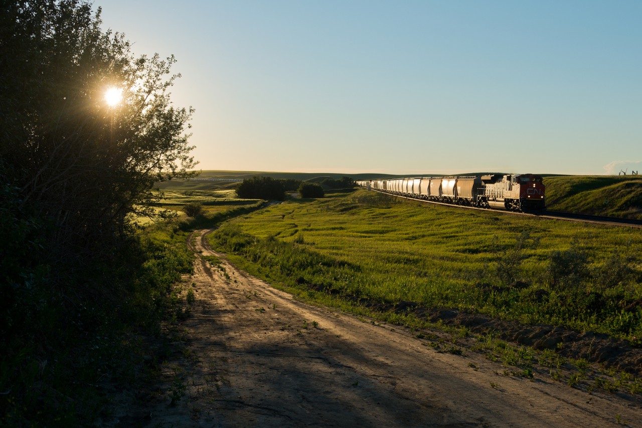 The time is 20:39 and the sun is inching closer and closer to the horizon in Keppel Saskatchewan. CN 8876 is the sole unit on train 210, a train consisting of 200 empty frac sand cars.