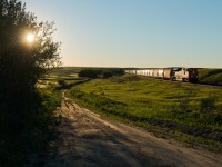 The time is 20:39 and the sun is inching closer and closer to the horizon in Keppel Saskatchewan. CN 8876 is the sole unit on train 210, a train consisting of 200 empty frac sand cars. 