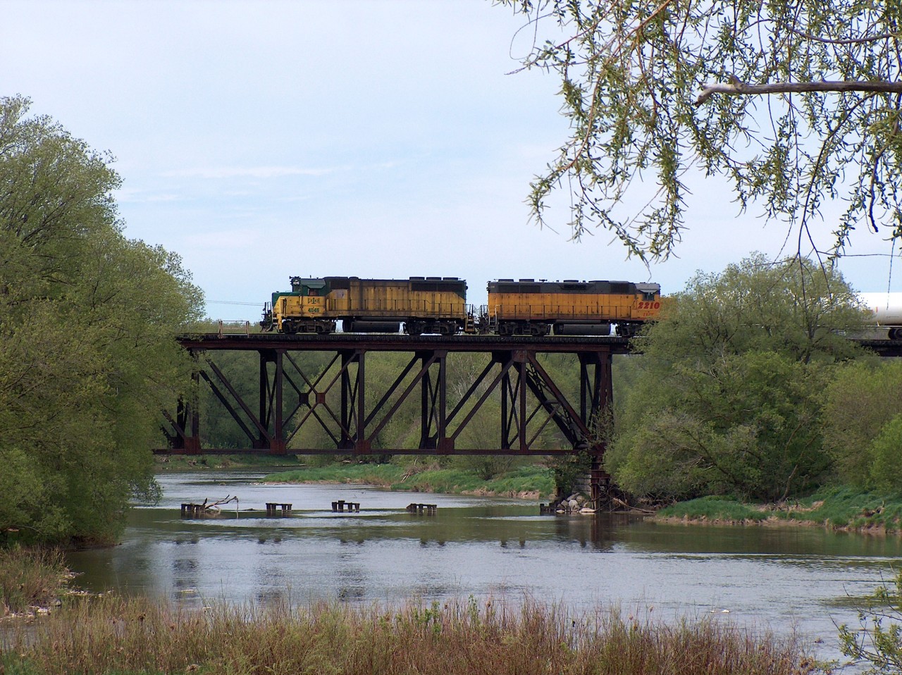 The GEXR local between Kitchener and Elmira is seen heading back south to Kitchener after switching an industrial facility in Elmira. It is pictured crossing the Conestogo in the quaint Mennonite village of St. Jacobs, just north of Waterloo. Glad I got these shots. Daylight GEXR operations in this time period on this line were much more common than present.