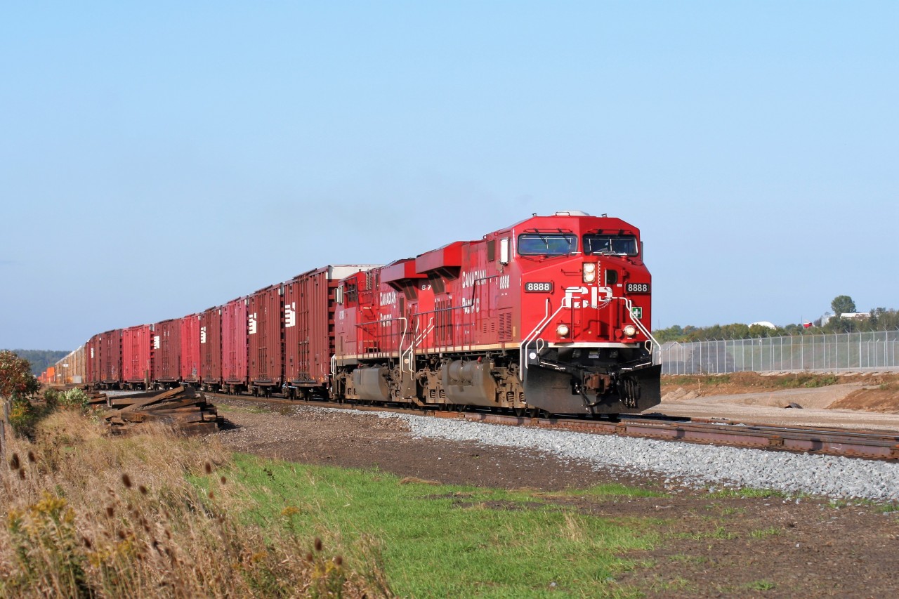 After meeting a westbound train, Canadian Pacific ES44AC 8888 and a sister lead an eastbound train out of the siding at Wolverton as the large new yard at the location was being constructed along the Galt Subdivision.