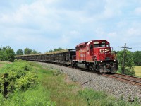 SD40-2, CP 5792 rolls around the bend at Victoria Road in Puslinch on the slow order for excessive heat hauling a full load of new track on its way to Toronto Yard. 