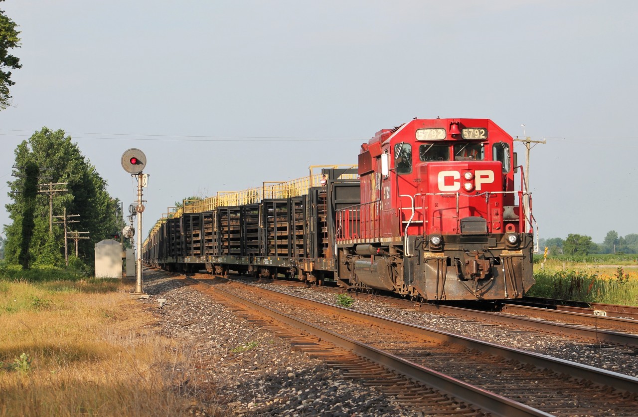 A loaded rail train enters the siding at WSS Bothwell to meet CP 141. 5792 is one of about 2 dozen SD40-2s CP has brought back into service this year. Interestingly, CP didn't actually repaint this unit into the new beaver scheme. They just added the decal next to the CP block letters so it wouldn't surprise me if this decal starts to come off prematurely in the near future.