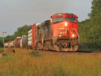 IC C44-9W 2705 and a Blue Devil Dash 8 lead a westbound train at Mile 44 as it approaches the Blain crossovers east of Woodstock, Ontario on CN’s Dundas Subdivision.