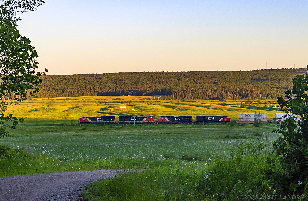 The sun is slowly starting to make it's way up over the horizon, as stack train Q120 rumbles it's way along at Dorchester, New Brunswick. Five minutes later, and this whole scene would be lit really nice, but for the time being, this is the result.
