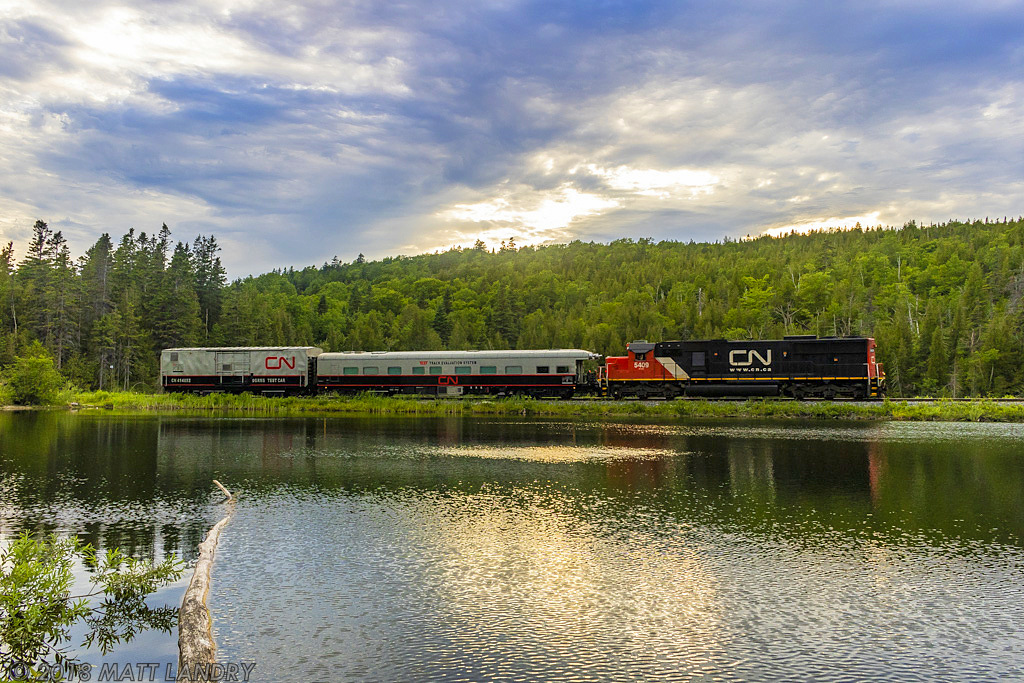 After arriving in Saint John and running around their train, CN test train O998 heads out of Saint John, running long hood, as they rumble by the unnamed lake, approaching Torryburn, New Brunswick.