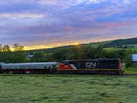 CN 5409, running long hood, leads test train O998, as they rumble by the country side at Norton, New Brunswick, with the sun beginning to set for another day. 