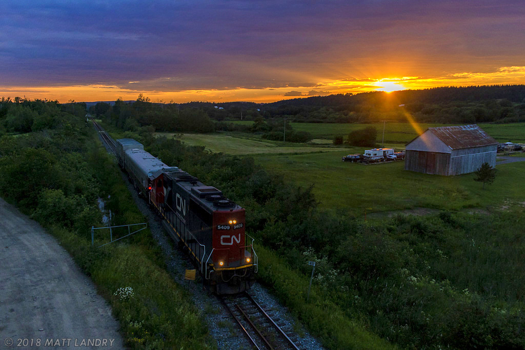 With the day's last bit of daylight left, CN 5409 leads train O998, the CN Test Train approaching Sussex, New Brunswick, running long hood forward.