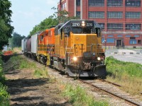 LLPX GP38AC 2210 and Goderich-Exeter Railway (GEXR) GP39-2u 2303 have four hoppers well in control as they lead train 518 into Kitchener from Stratford on a pleasant summer early afternoon. 