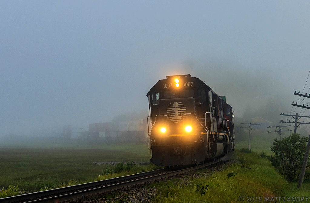 With a deathstar on the point, CN Q120 rounds the foggy S-Curve at Upper Dorchester, New Brunswick.