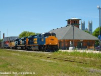 Another of 'my' Oldies again. July, the time of year of high weeds. In 2018 the weeds are really bad - higher than our country's infatuation with.. weed. Avoid. So this is an oldie? Well, it's only been 14 years, but let's see what's different: The CSX engines are off the roster, Guelph Station does NOT look like this anymore as Metrolinx has added their 'improvements', and where I'm standing there's a fence or a Steam locomotive in the way. Also Both GEXR units in this photo are off the roster - LLPX 2210 was blown up and sent away for repair never to come back, and RLK 2210 re-numbered 2211 to avoid confusion - is out of service. Could it return?<br><br>For the un-initiated (read: kids born after 2000) when the EMD London plant was really busy with new products, they tended to test new units on the Guelph sub with help of local railways, and GEXR was a very willing participant.This was the first run of the CSX locomotives and interest was VERY high from local 'fans. Pairs of CSX units, sometimes with GEXR assist power, sometimes without would test some days, and on others, just regular GEXR power. They even tested one or two BNSF units and a pair of  UP units (the UP's only ran at night.. ONCE!) Who remembers GEXR's Police/Security they briefly had to help stop vandalism on these locomotives in Stratford and the police cruiser? Didn't last long.. and the guy had quite the reputation for being a 'bull'. Train is eastbound 432 - which ran around Lunchtime - if you were lucky a light power 432 could roll by around 10-11 AM in better light, but westbound was much better<a href=http://www.railpictures.ca/?attachment_id=26340 target=_blank> and I was there to capture the westbound run that day.</a> 