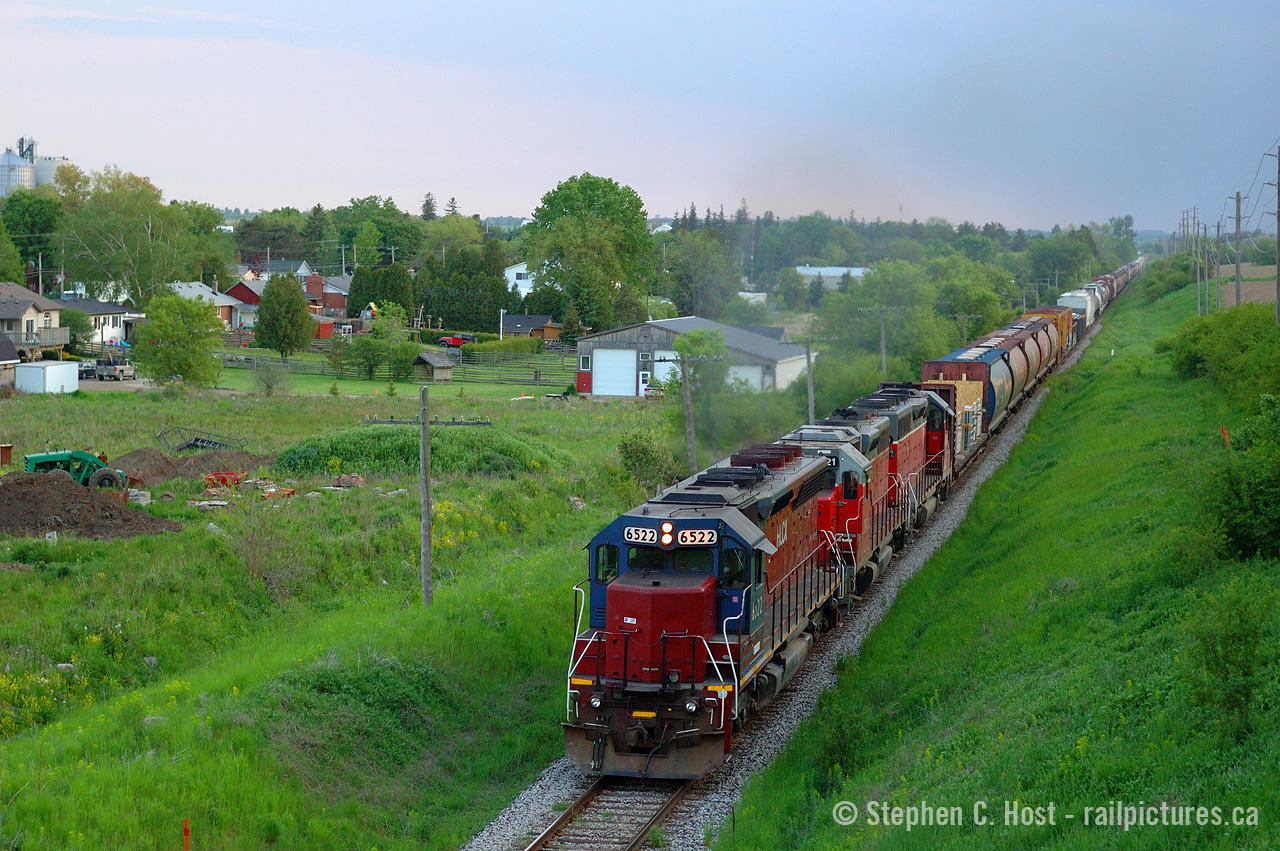 This is an era of GEXR that was not often photographed, as they ran at night. Also, I wasn't a huge fan of the motive power, but I was able to get a couple photos here and there. Outside of locals, photos of 432/1 from the darkness era 2008 to what, 2012? are hard to come by due to the night ops, also an eastbound at dinner was photography hell as you'd be shooting into the sun. Imagine my surprise when I found this in my archives, it's not that half bad! Around the time of G&W Takeover 432/1 returned to daylight and ran in perfect timeslots for photography, and still does.

This photo was taken at 8:31 PM from Jones Baseline Rd. At least we have the right leader, Built in 1968 as DRGW 5334 as a SD45, rebuilt as an EMD SD40M-3, HLCX 6522 leads 3821 and 4019 on 432 just outside of the City of Guelph.
Photo notes: Nikon D70, 50mm fixed lens at f/2.5 to keep the shutter speed fast in rapidly failing light.