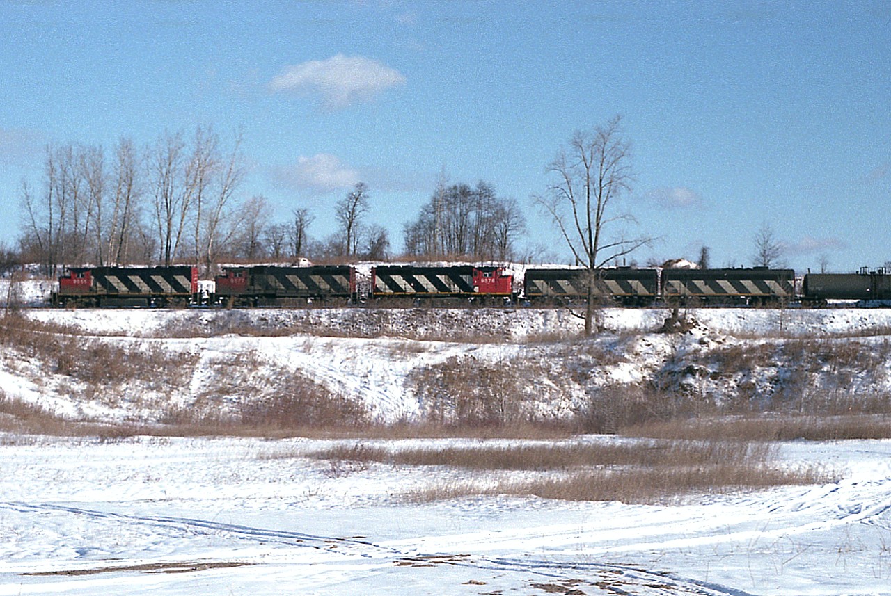 Five units. Ah jeez, where to shoot it. Of course the power I wanted to photograph is trailing. Anyway, ended up where there was an open field and the foliage was mostly gone; so shot this westbound train just before it was about to cross over St. Paul Av, the main road into St. Davids. Came out not too bad for a broadside shot: CN 9555, 9577, 9578, 9195 and 9198. The B units used to be based in Fort Erie back then, I believe.