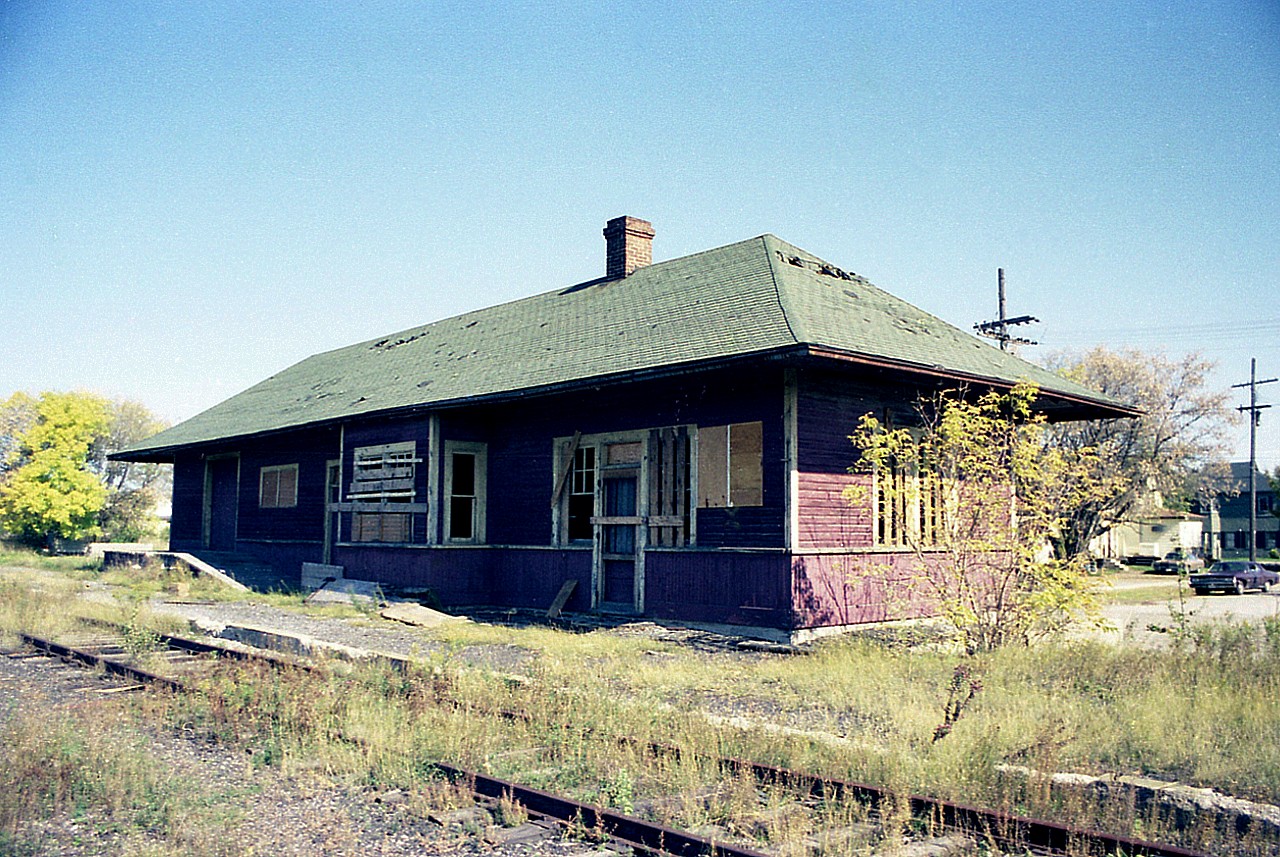 This area had its railroad beginning back in the days of the Lake Simcoe Junction Railway. Turn of the century. Eventually became Grand Trunk and then CN. The CN Sutton Sub became a spur by 1960. Service on the line ended in Aug 1979 and the tracks were pulled up beginning July 1981.  This old shot gives an indication of the state of disrepair the old station was in by fall of 1976. It was very fortunate that a group with some foresight in regards to preserving the past started up the Georgina area Pioneer Village in 1975. The station, on site since 1906, was eventually moved and restored at the Village not long after this photo was taken.